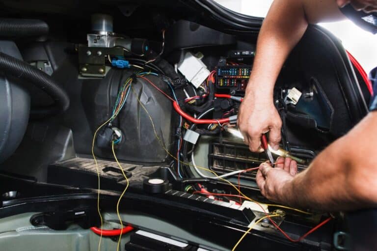 Mechanic repairing electrical system of a car