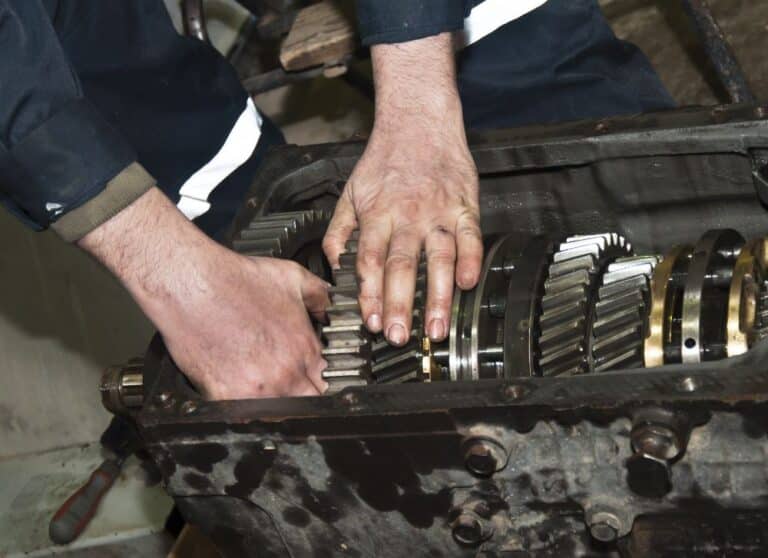 Mechanic dismantling a transmission