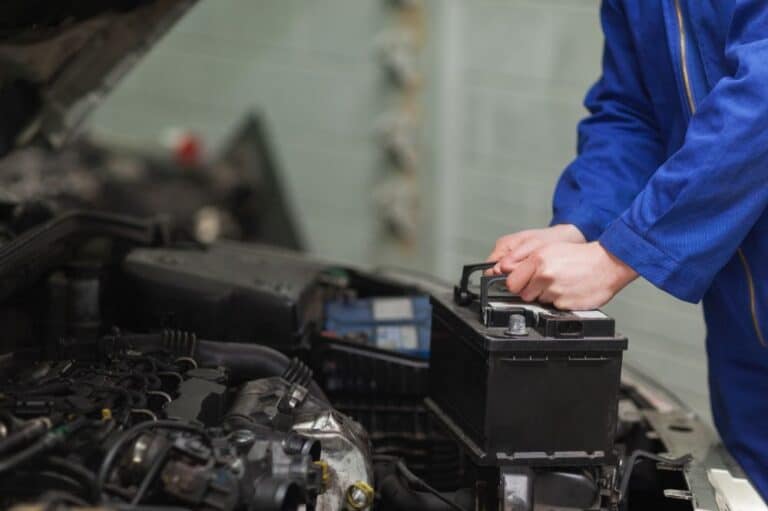 Mechanic installing a battery