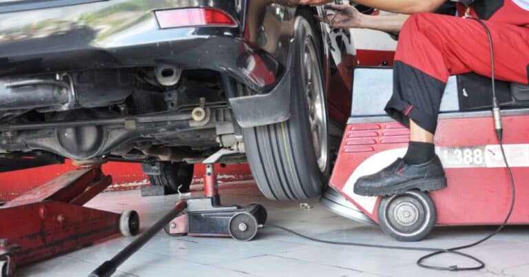 Car on lift being inspected