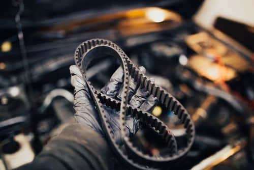 Timing belt held by a mechanic